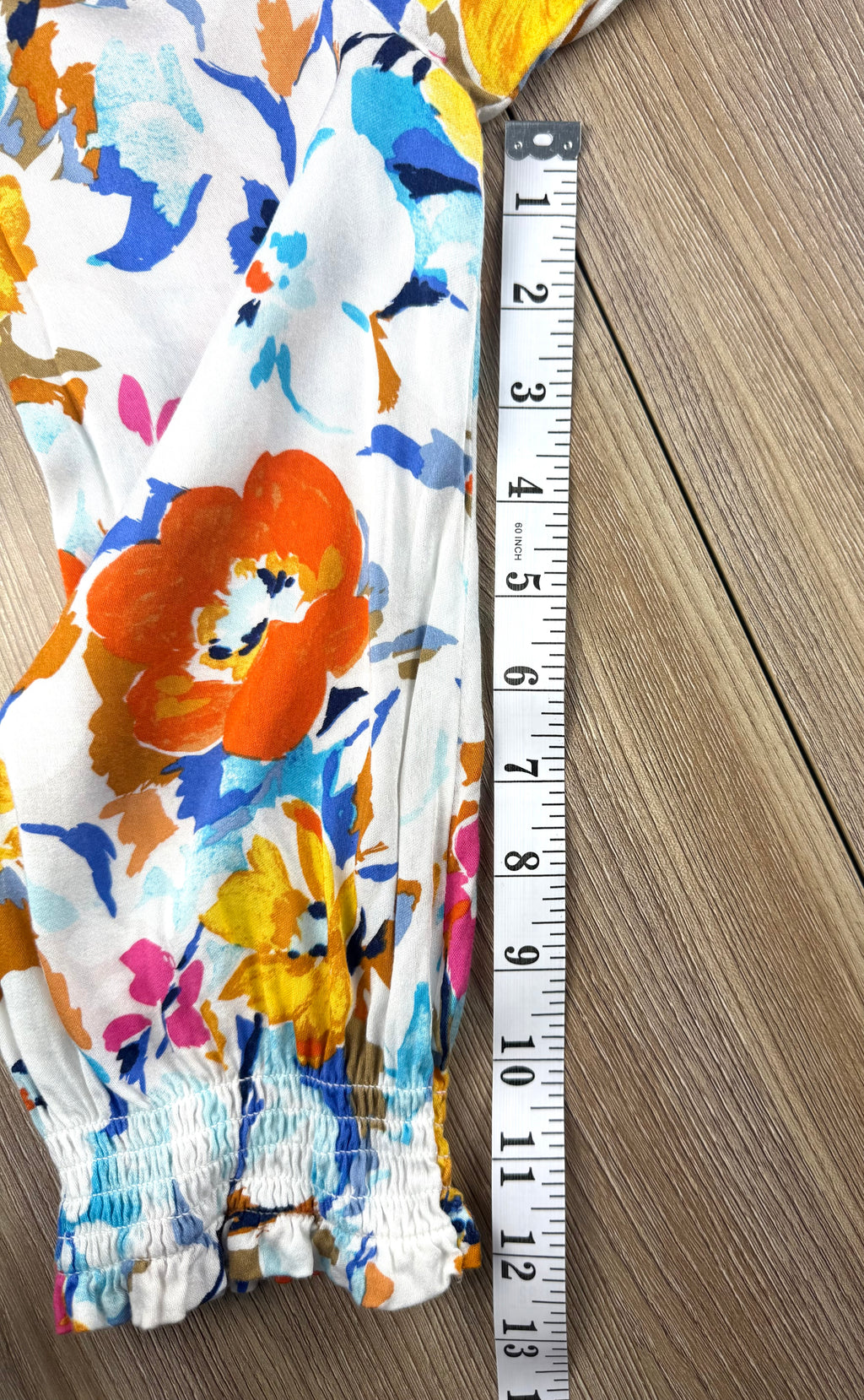Tribal floral spring top measuring 12" sleeve 