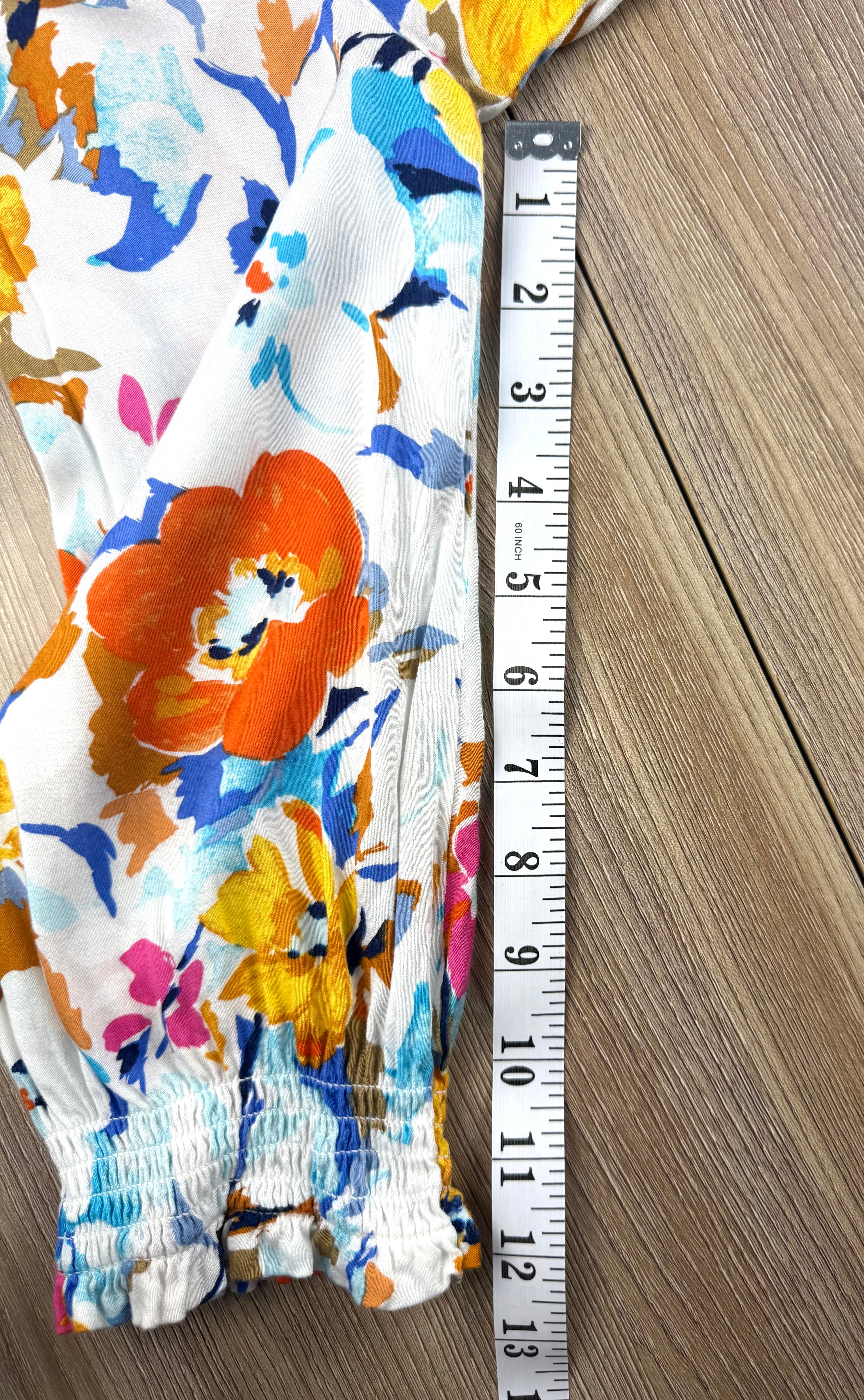 Tribal floral spring top measuring 12" sleeve 