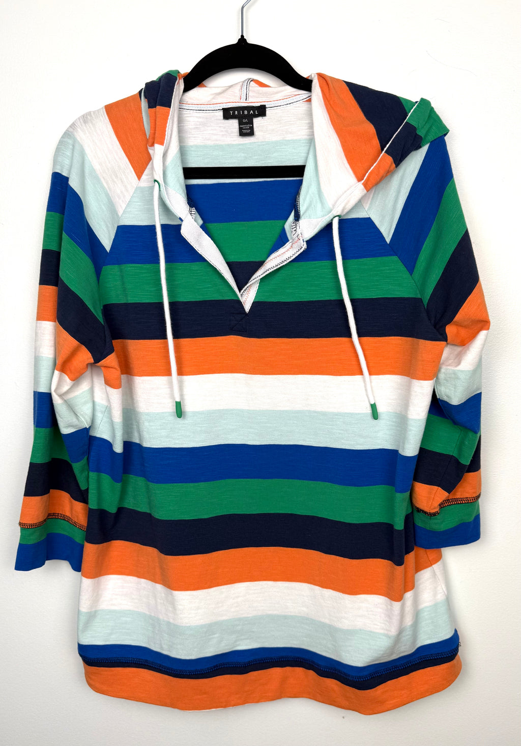 Tribal striped rugby style hooded pullover on hanger