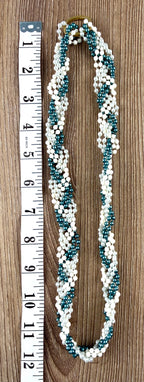 Twisted multi-strand white and teal faux pearl bead necklace laid flat with measuring tape, full length view, gold-tone barrel clasp visible — Blue Sparrow pre-loved jewellery