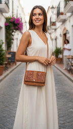Vintage Hand-Tooled Leather Crossbody Bag at Blue Sparrow Shop on woman outdoors