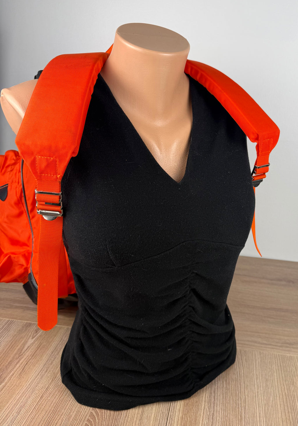 Vintage World Famous Hiking Backpack showing straps on front of mannequin for scale 