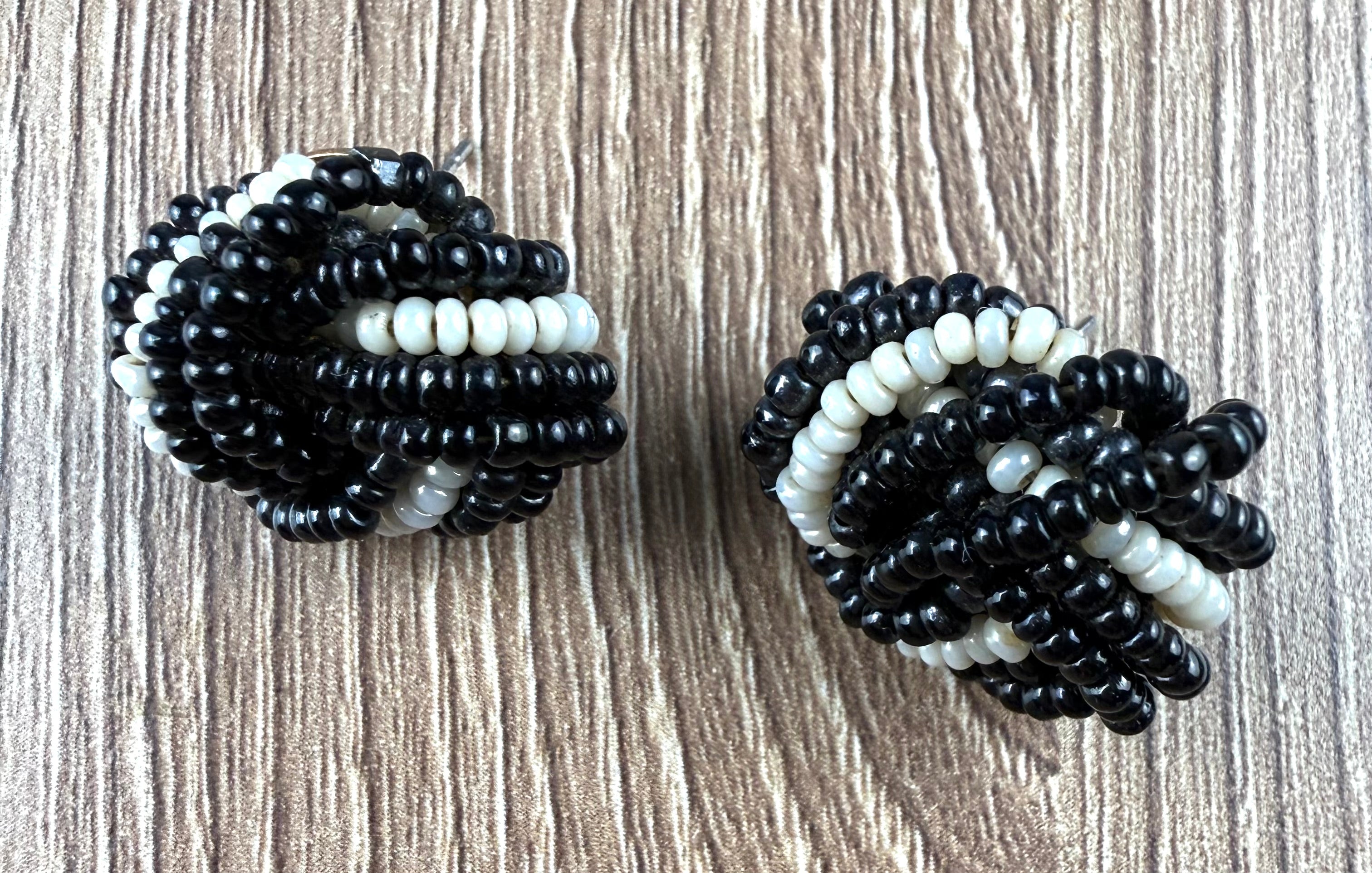 Vintage black and white beaded knot earrings retro seed bead jewellery on desk