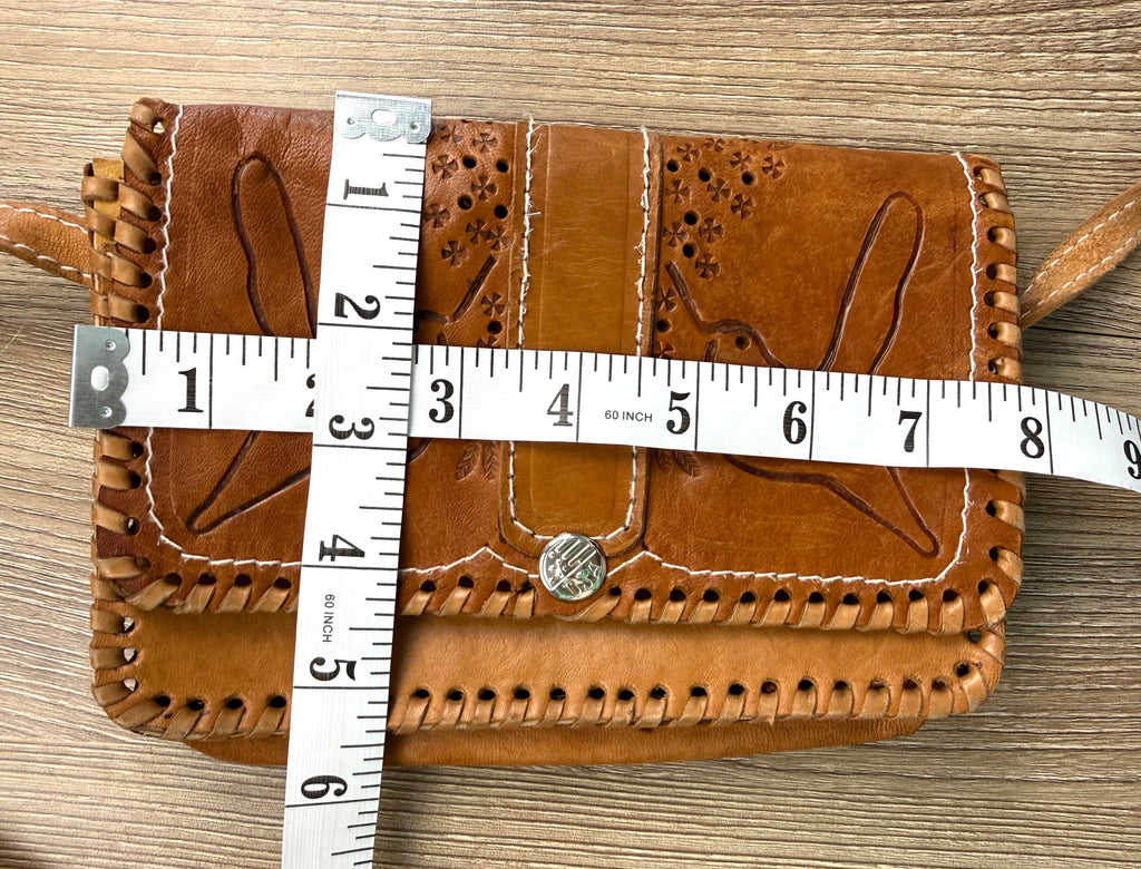 Vintage hand tooled leather crossbody bag at Blue Sparrow Shop measuring 8" x 6" 