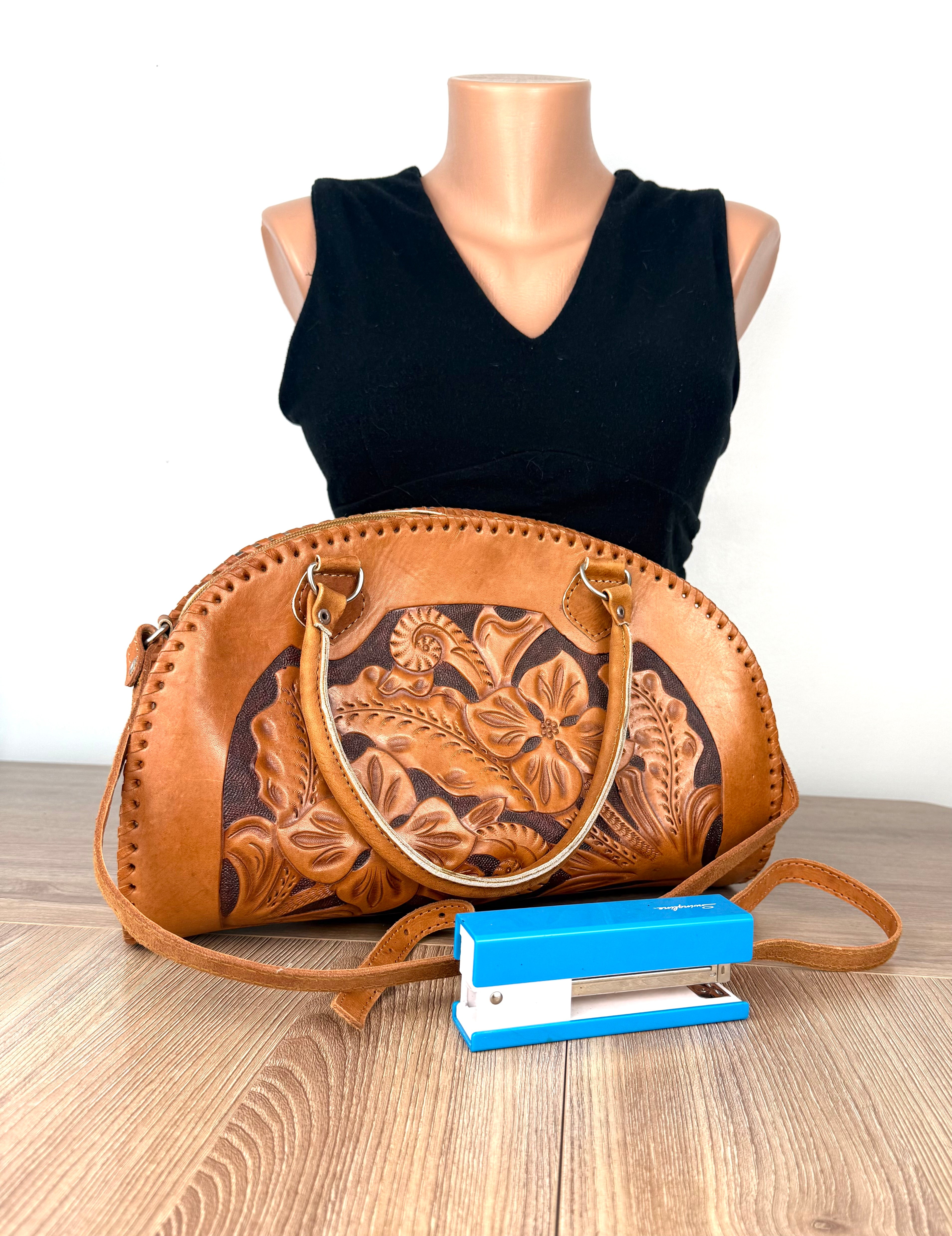 Vintage leather dome handbag shown with stapler for size comparison