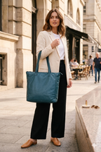 Wanderers Travel Co Leather Parisian Tote Bag at Blue Sparrow Shop - woman carrying it on street