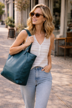 Wanderers Travel Co Leather Parisian Tote Bag woman walking carrying it