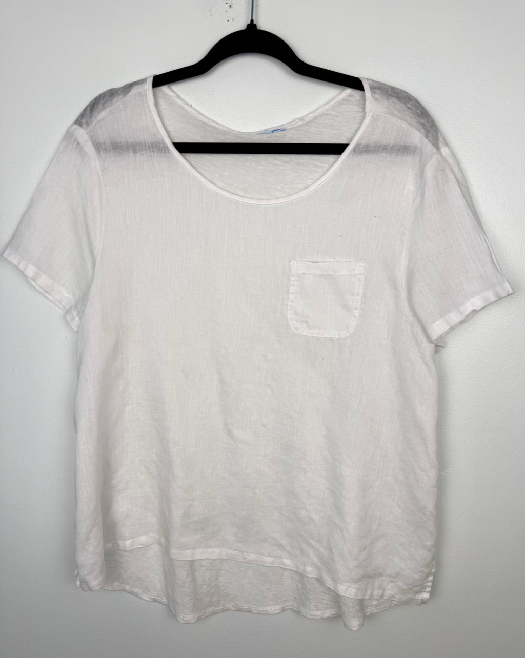 White linen blend basic, boxy, short sleeve tee with chest pocket at Blue Sparrow Shop front of top on hanger