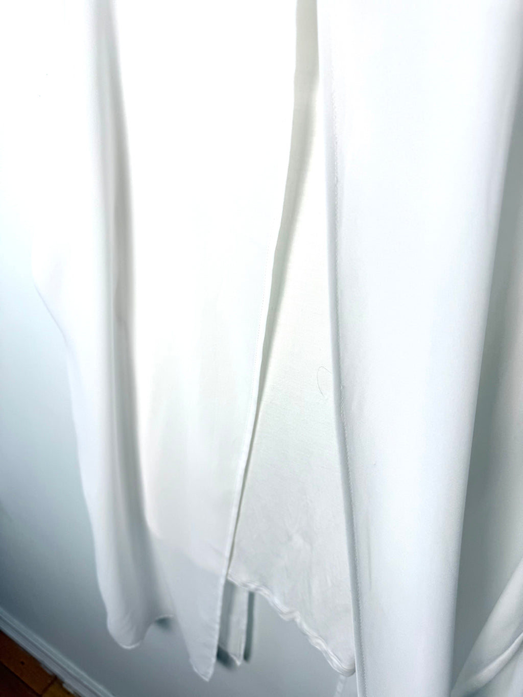 White split front tunic women longline sleeveless layering top flowy viscose blouse showing hem with open top layer
