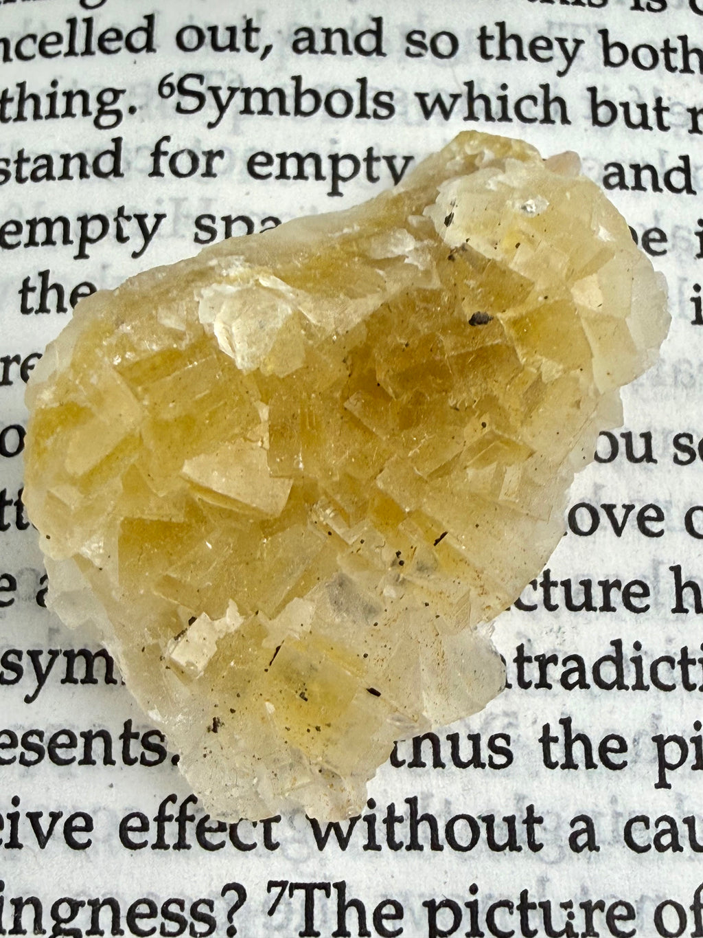 yellow fluorite crystal on book 