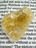 yellow fluorite crystal on book 