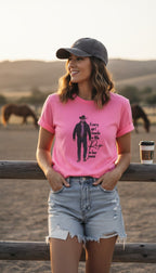 Yellowstone Fan Graphic Tee in Pink | Size S at Blue Sparrow Shop Canadian Resale on woman in shorts and ballcap against rail fence