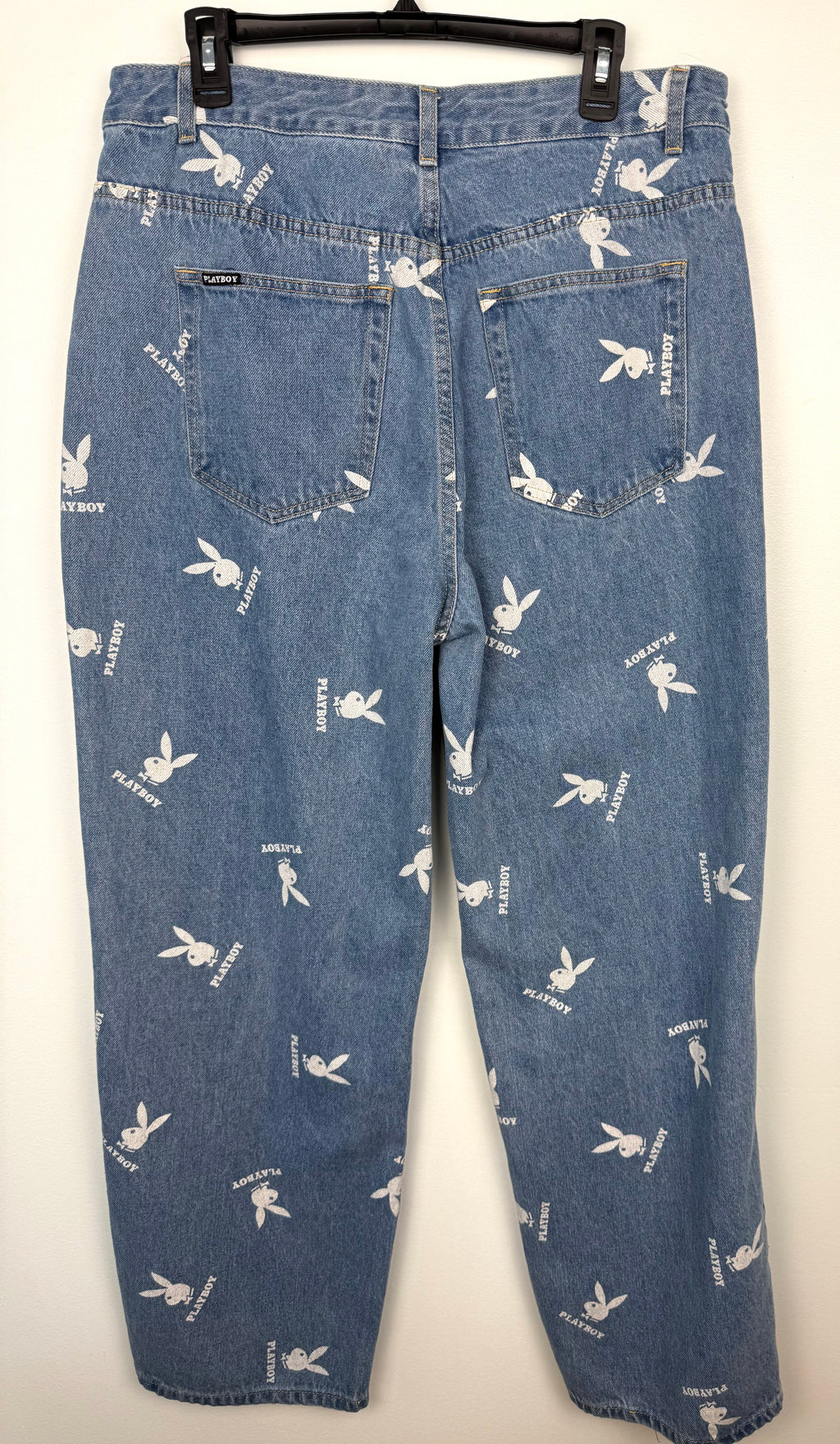 back of 100% Cotton Playboy Bunny Print Wide Leg Jeans | Size 13 at Blue Sparrow Shop on hanger