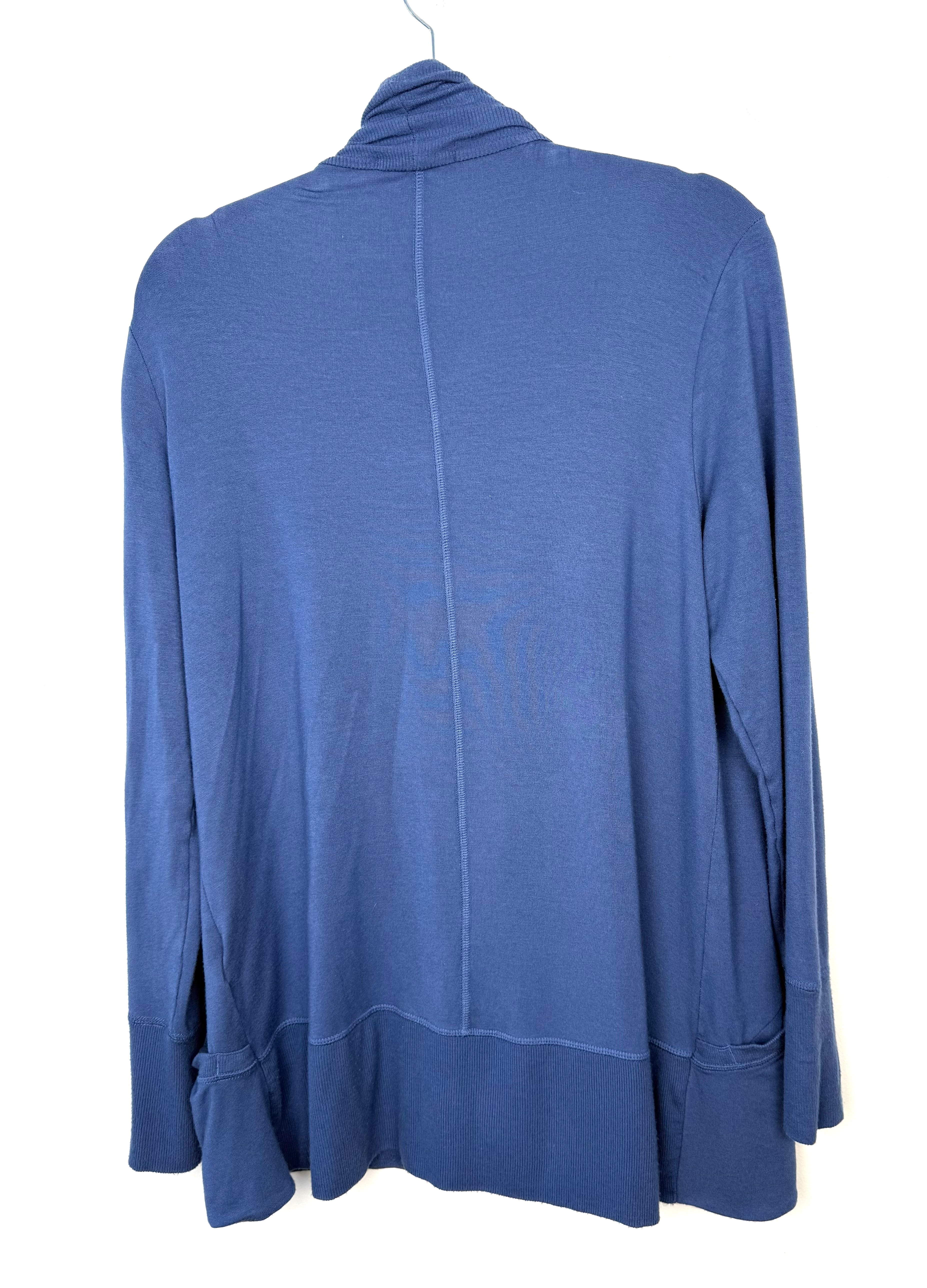 back of Athleta Pranayama wrap cardigan in blue, open front drape style with ribbed shawl collar and front pockets, women’s athleisure layering piece.