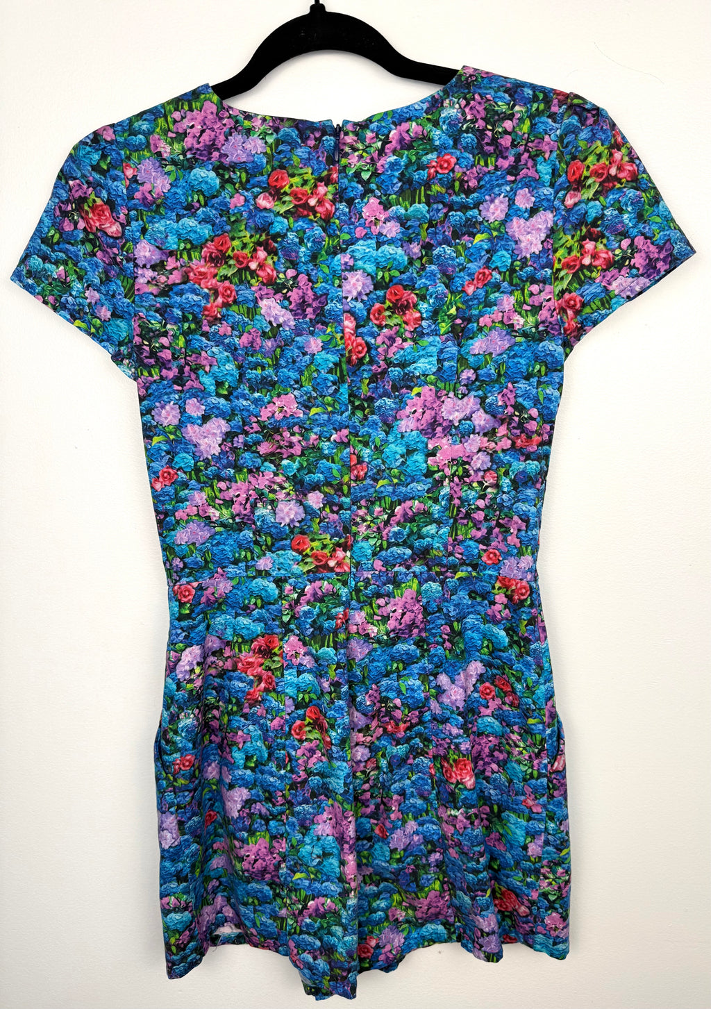 back of Birds of North America floral romper with impressionist hydrangea print on hanger