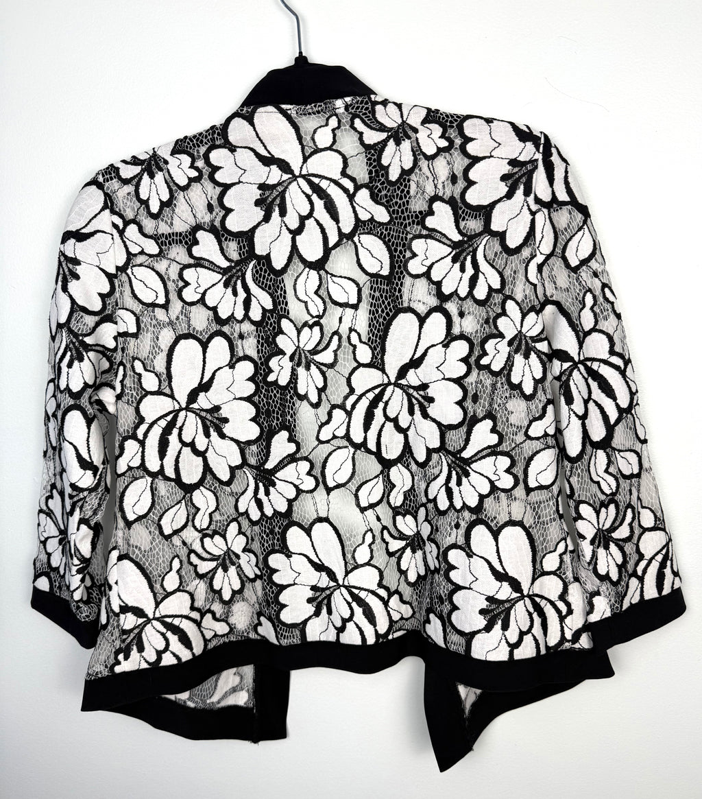 back of Black and white floral lace open front cardigan, lightweight sheer lace jacket with cropped silhouette and 3/4 sleeves on hanger
