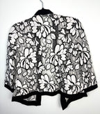 back of Black and white floral lace open front cardigan, lightweight sheer lace jacket with cropped silhouette and 3/4 sleeves on hanger