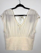 back of Boho Embroidered V-Neck Top Smocked Waist | Size L  at Blue Sparrow Shop on hanger