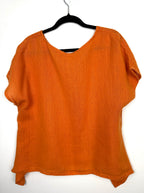 back of Burnt orange cotton short sleeved oversized top at Blue Sparrow Shop  on hanger