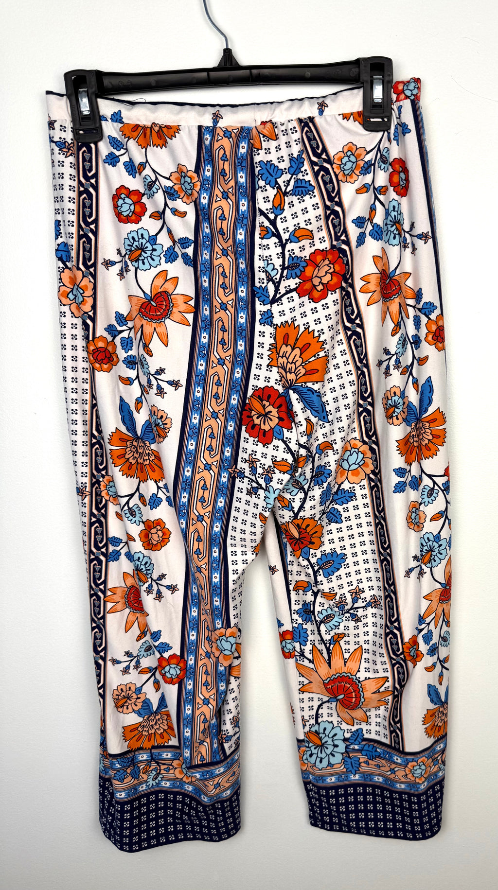 back of Casual boho patterned wide leg pants in orange and blue  on hanger