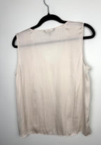 back of Cream Banana Republic sleeveless blouse featuring a V-neckline, gathered shoulder detail, relaxed silhouette, and fluid drape throughout the body on hanger