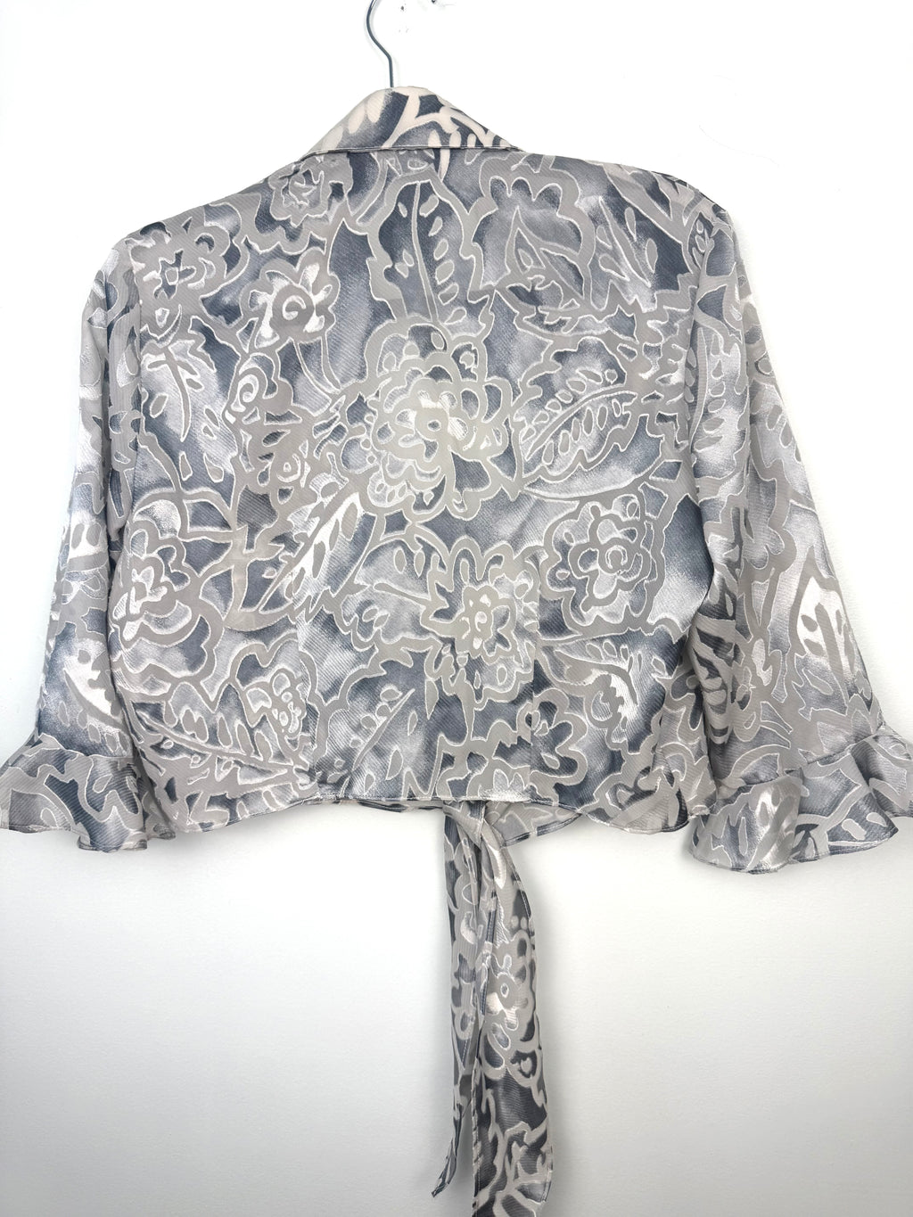 back of Cropped Chiffon Bolero Jacket on hanger
