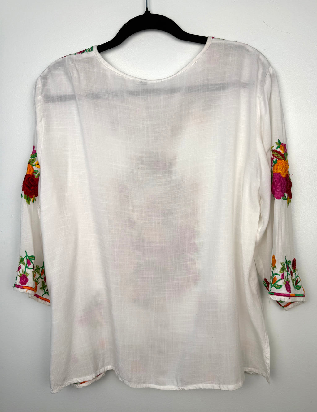 back of Embroidered Floral Tunic Blouse on hanger
