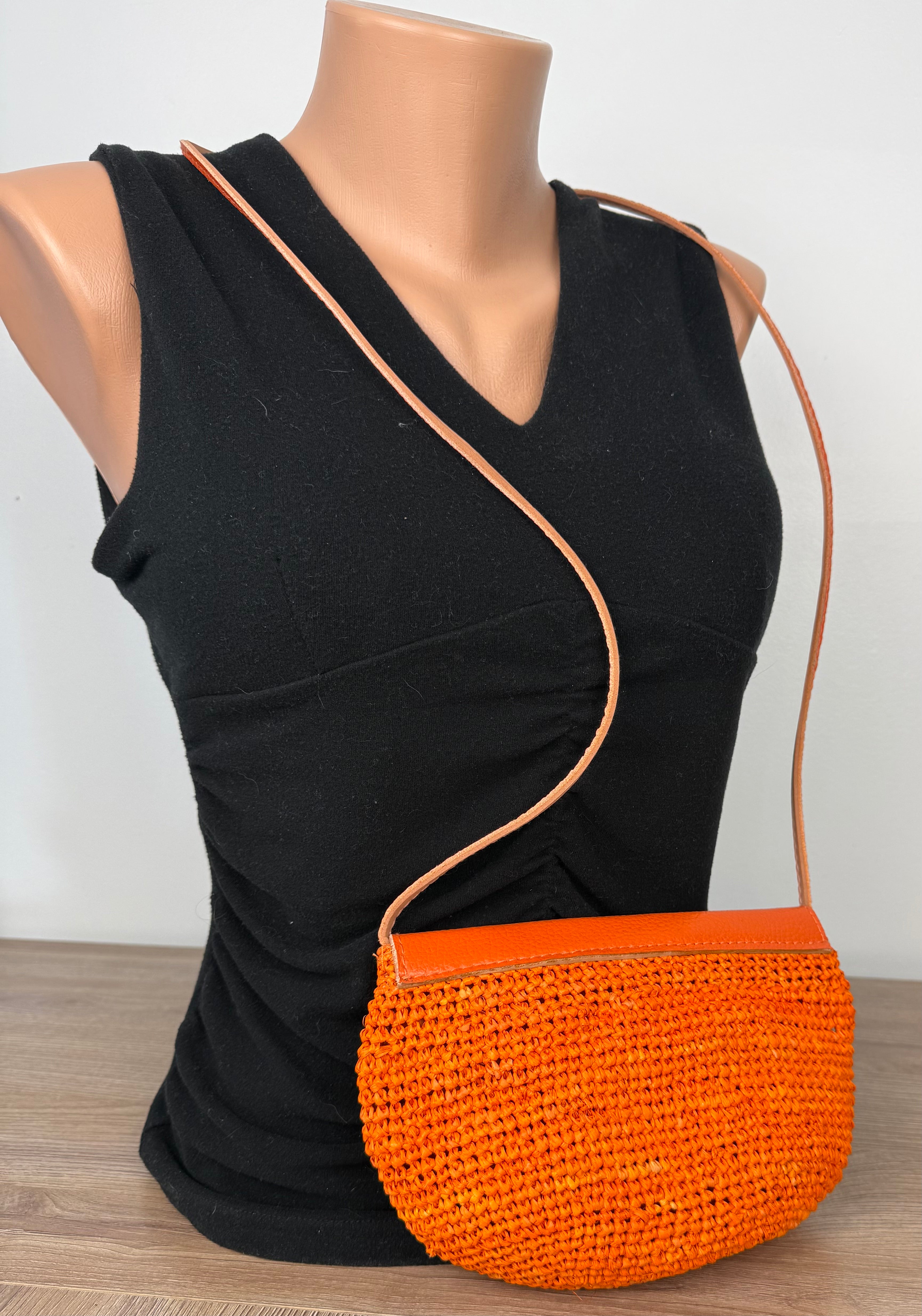 back of Handmade Madagascar 100% raffia orange crossbody bag leather flap   at Blue Sparrow Shop
