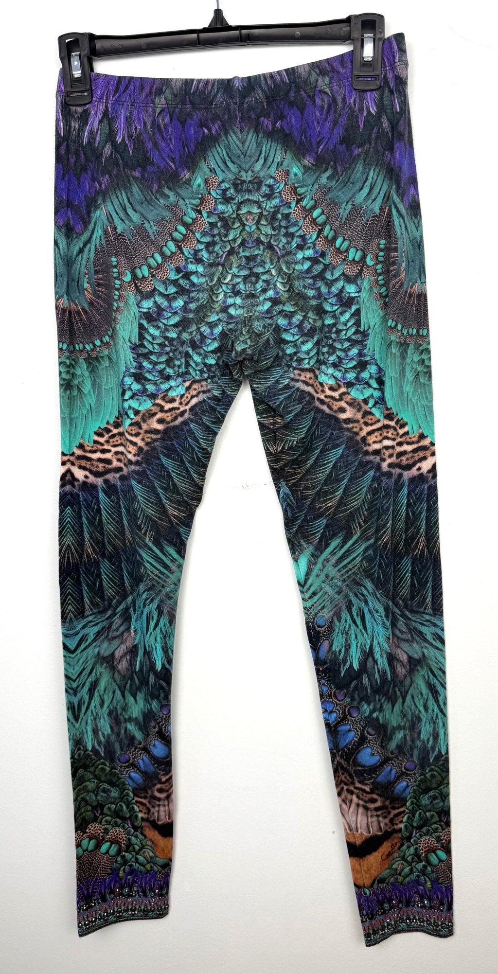 back of Luxury Camilla Franks resort wear leggings featuring a vibrant animal print design with crystal embellished ankle detailing on hanger