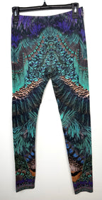 back of Luxury Camilla Franks resort wear leggings featuring a vibrant animal print design with crystal embellished ankle detailing on hanger