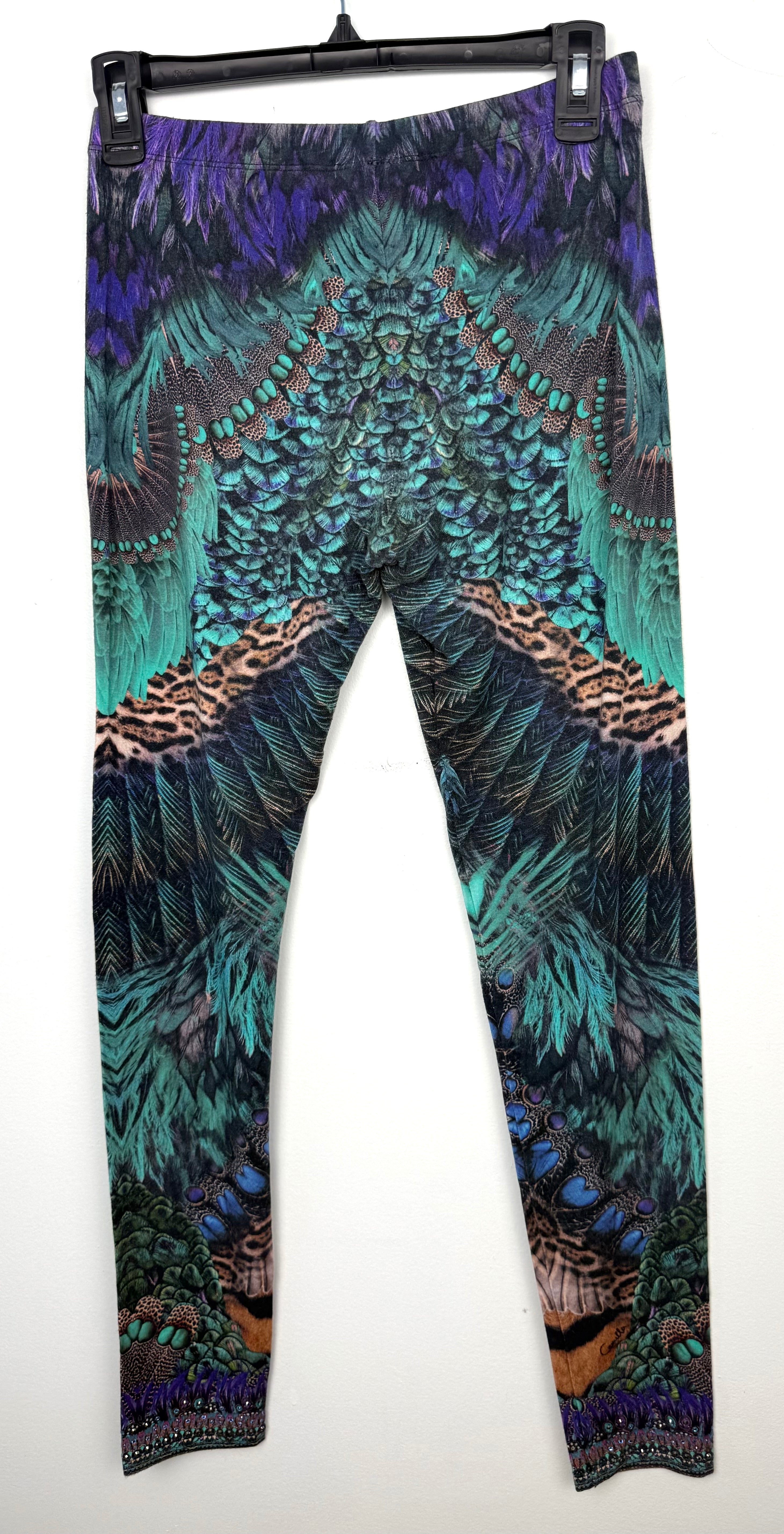 back of Luxury Camilla Franks resort wear leggings featuring a vibrant animal print design with crystal embellished ankle detailing on hanger