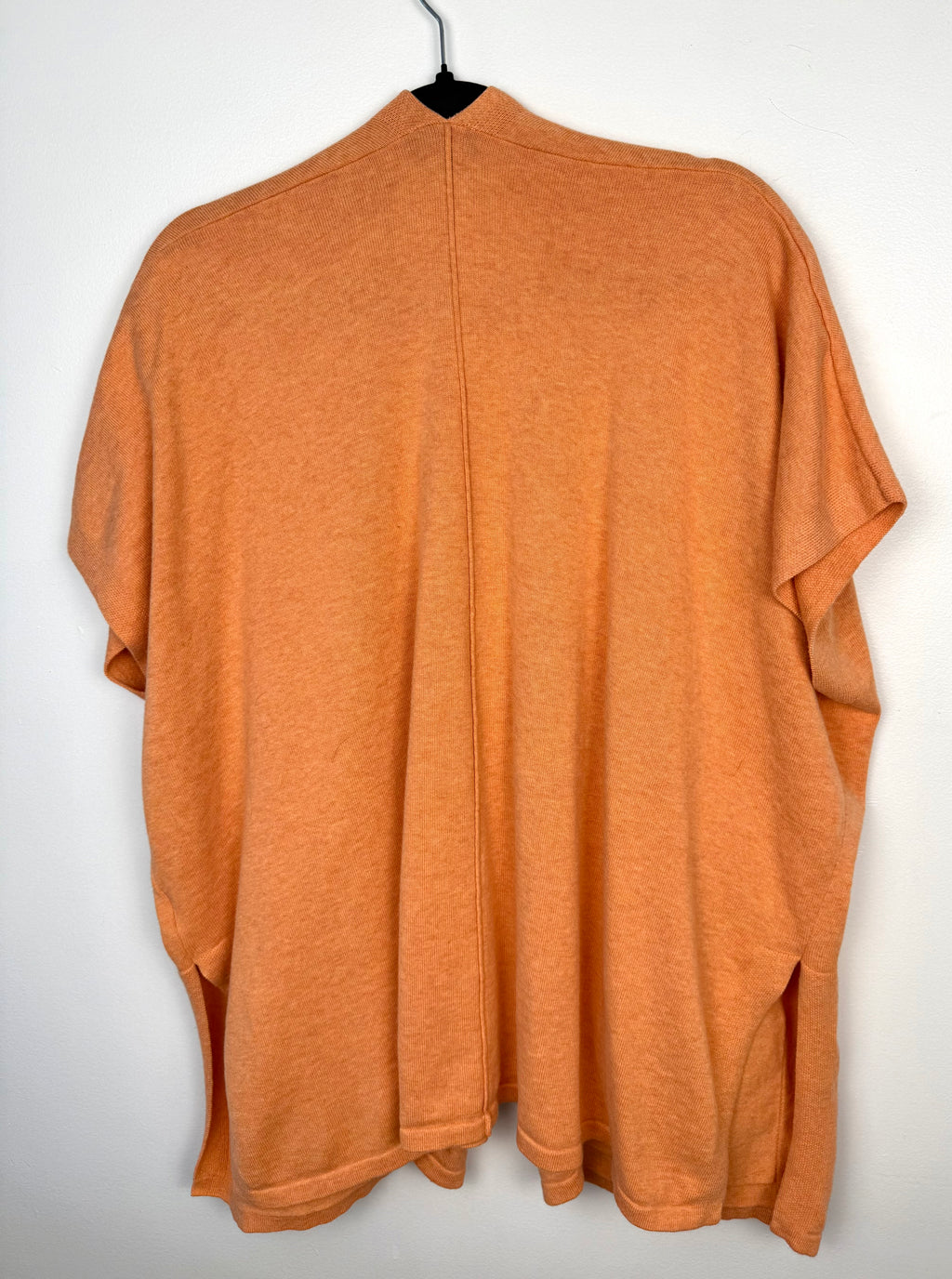 back of Marble UK brand knit kimono shawl or lightweight cardigan in peach  on hanger
