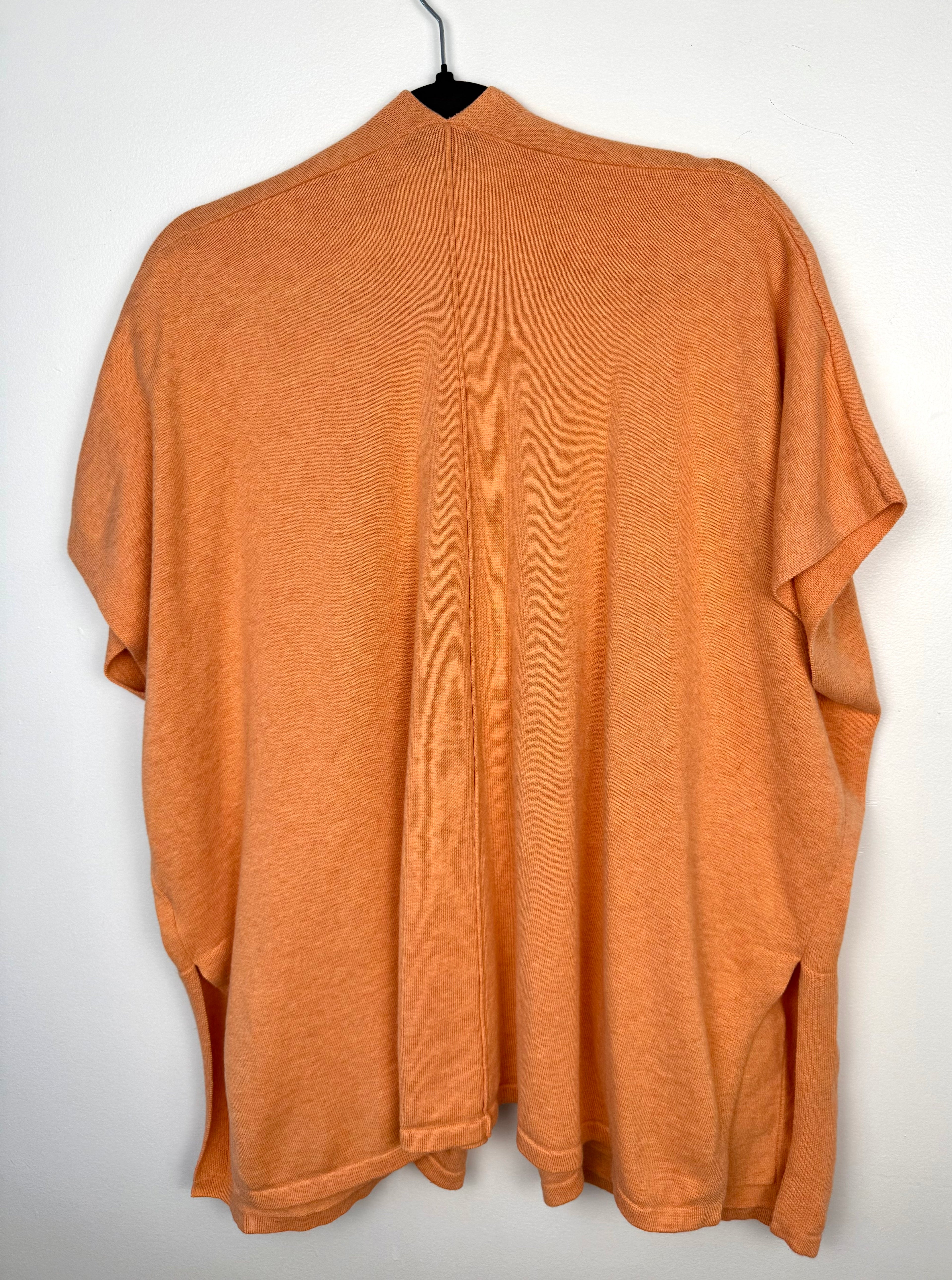 back of Marble UK brand knit kimono shawl or lightweight cardigan in peach  on hanger
