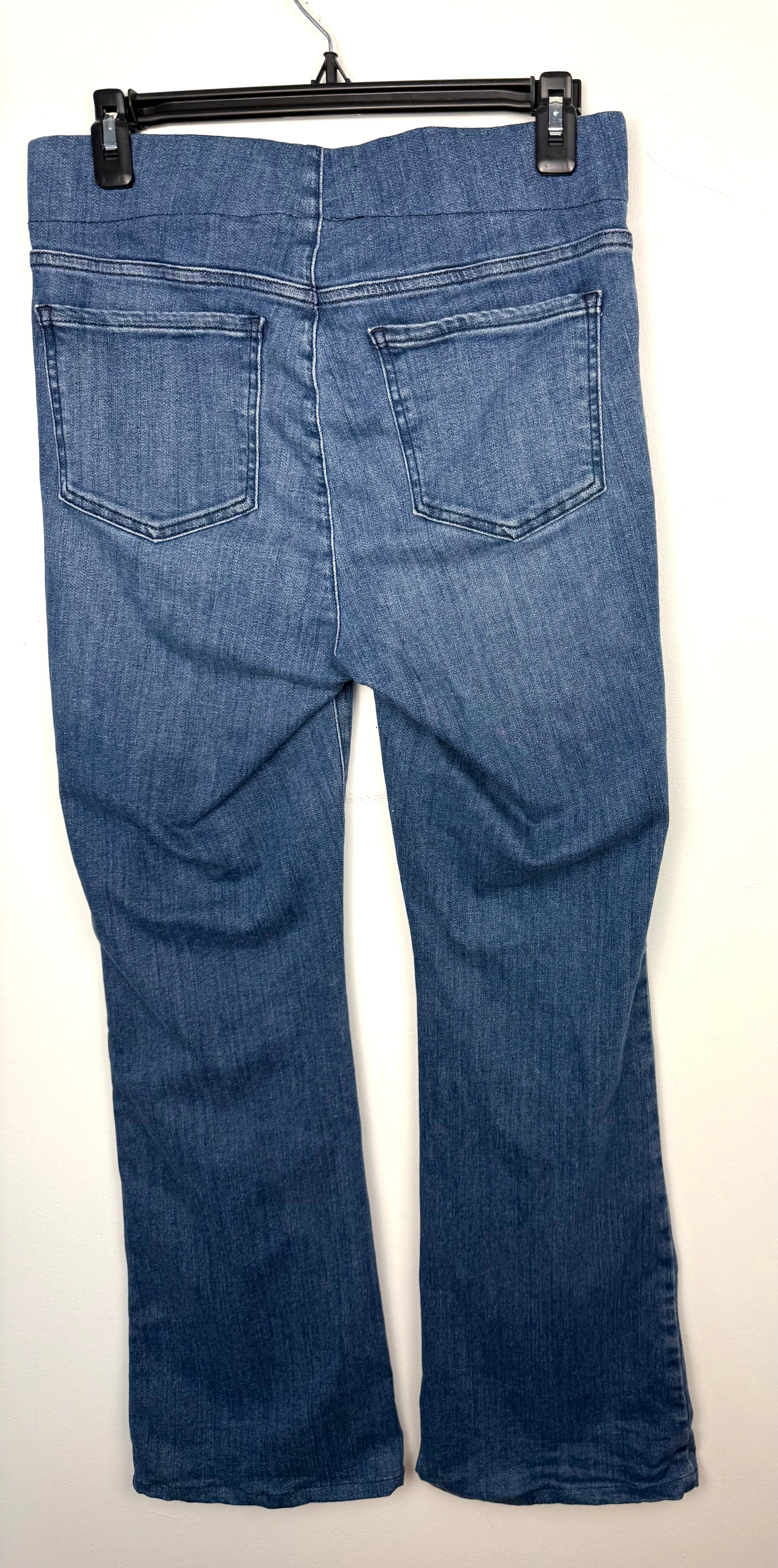 back of NYDJ Foundry Pull-On Bootcut Jeans – Medium Wash Stretch Denim Jeans on hanger