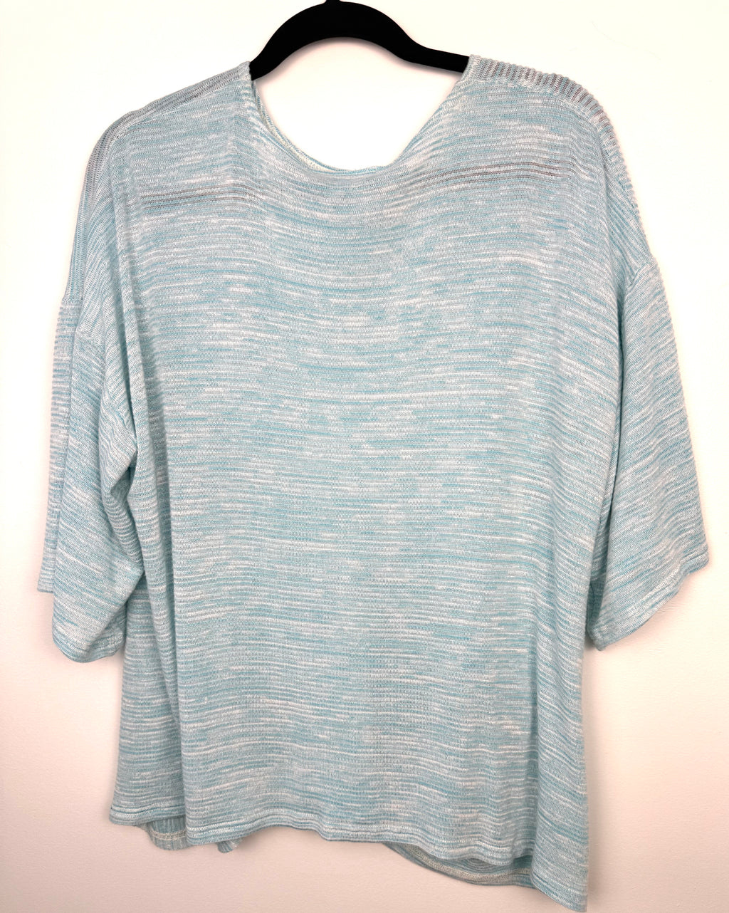 back of Pale Blue Sympli Knit Tunic Top with front pocket detail  on hanger