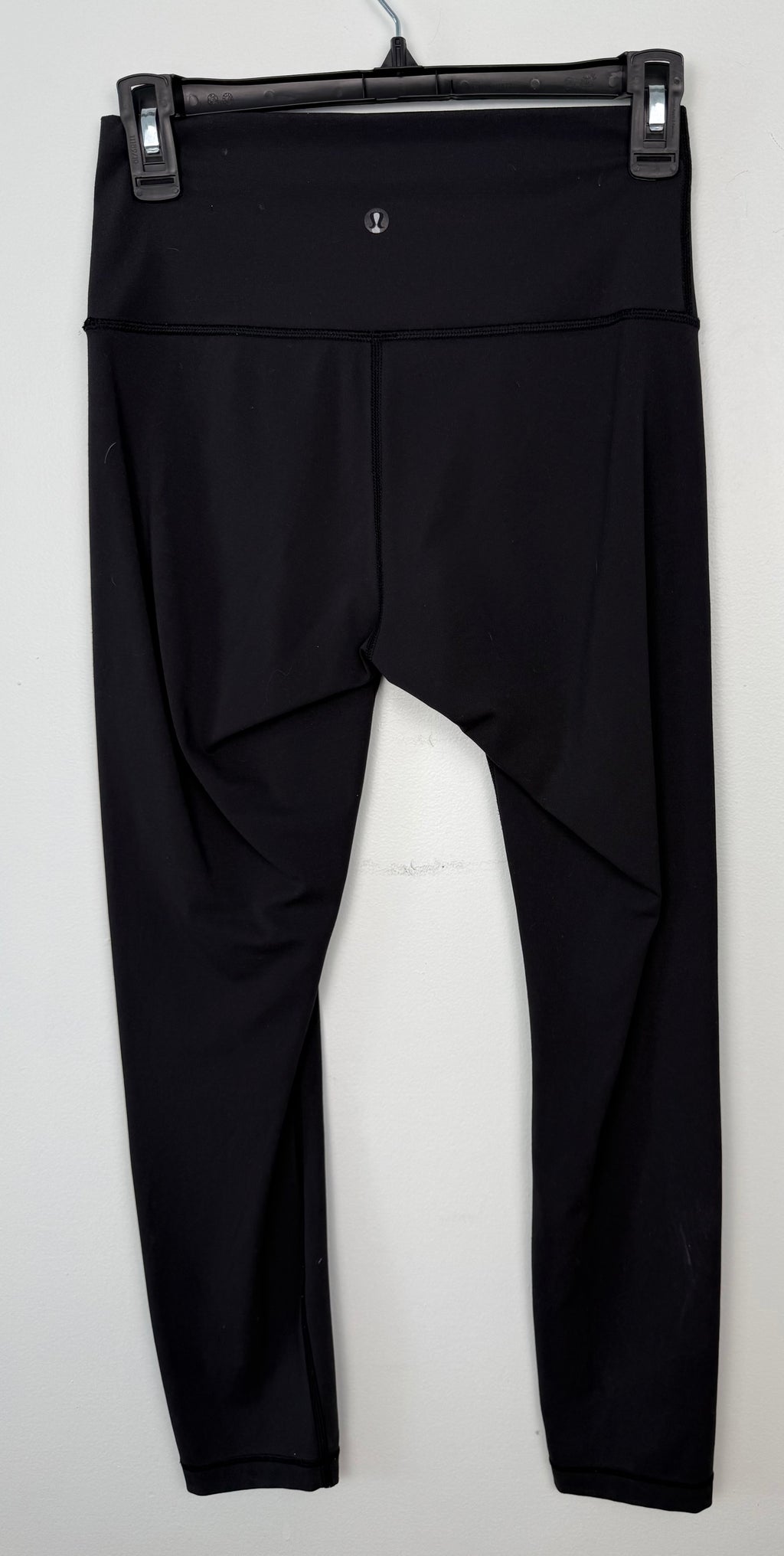 back of Pre-loved Lululemon Black High Waisted Leggings | Size 6 at Blue Sparrow Shop on hanger