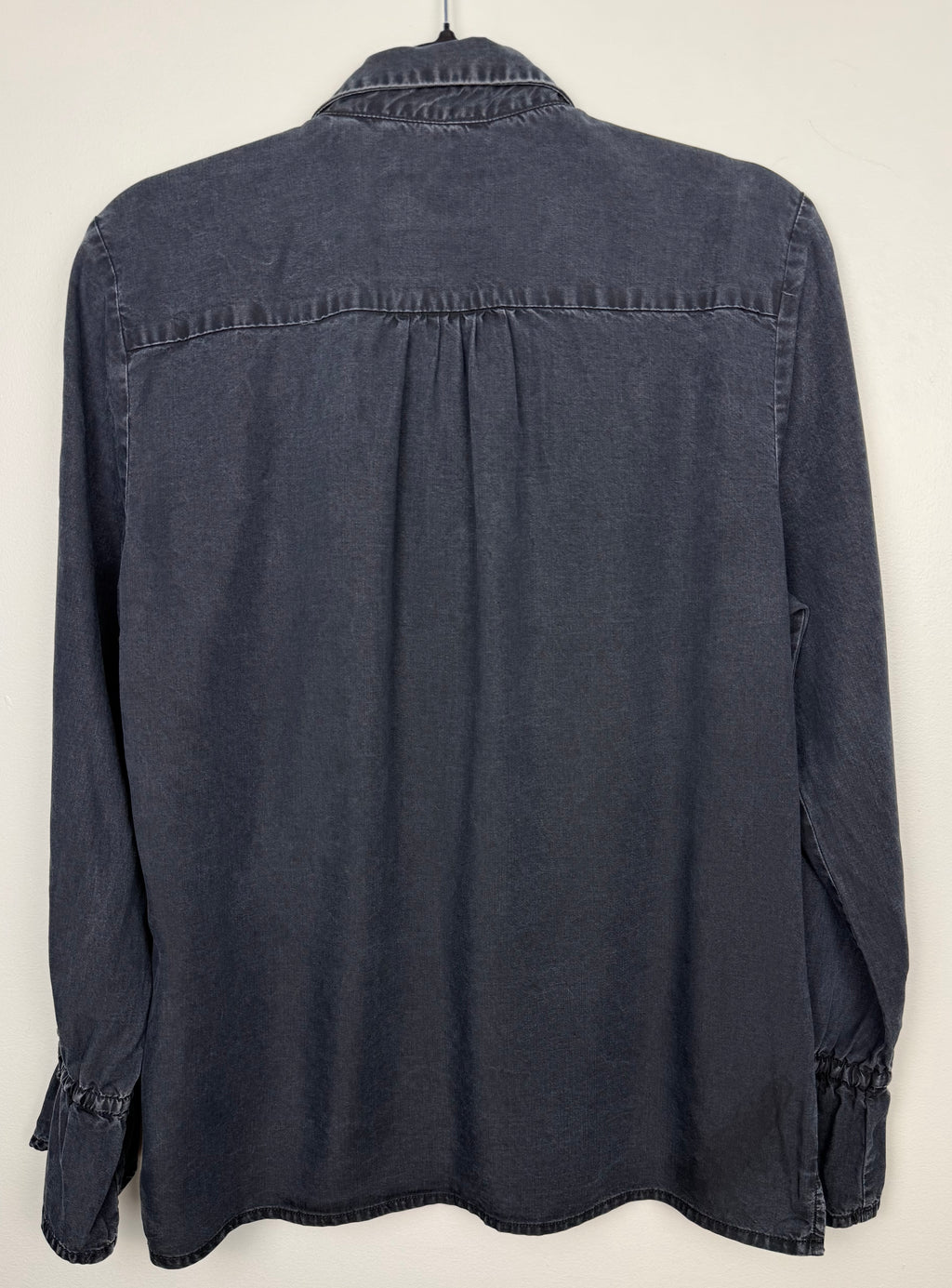 back of Sandwich Denim Studio Amsterdam charcoal 100% Tencel shirt with stunning hand-applied blue crystal collar embellishment and ruffle cuff detail at Blue Sparrow Shop on hanger