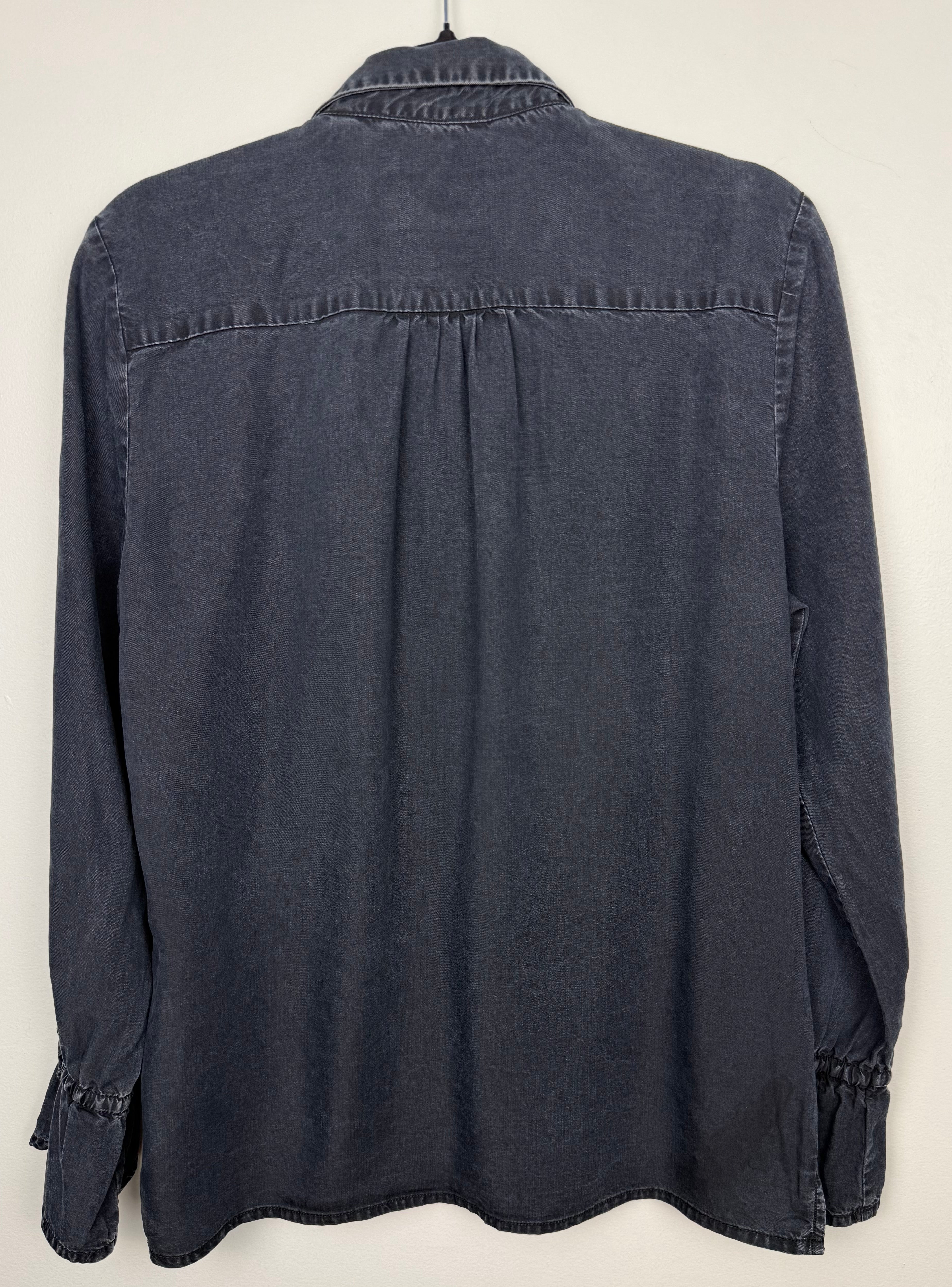 back of Sandwich Denim Studio Amsterdam charcoal 100% Tencel shirt with stunning hand-applied blue crystal collar embellishment and ruffle cuff detail at Blue Sparrow Shop on hanger