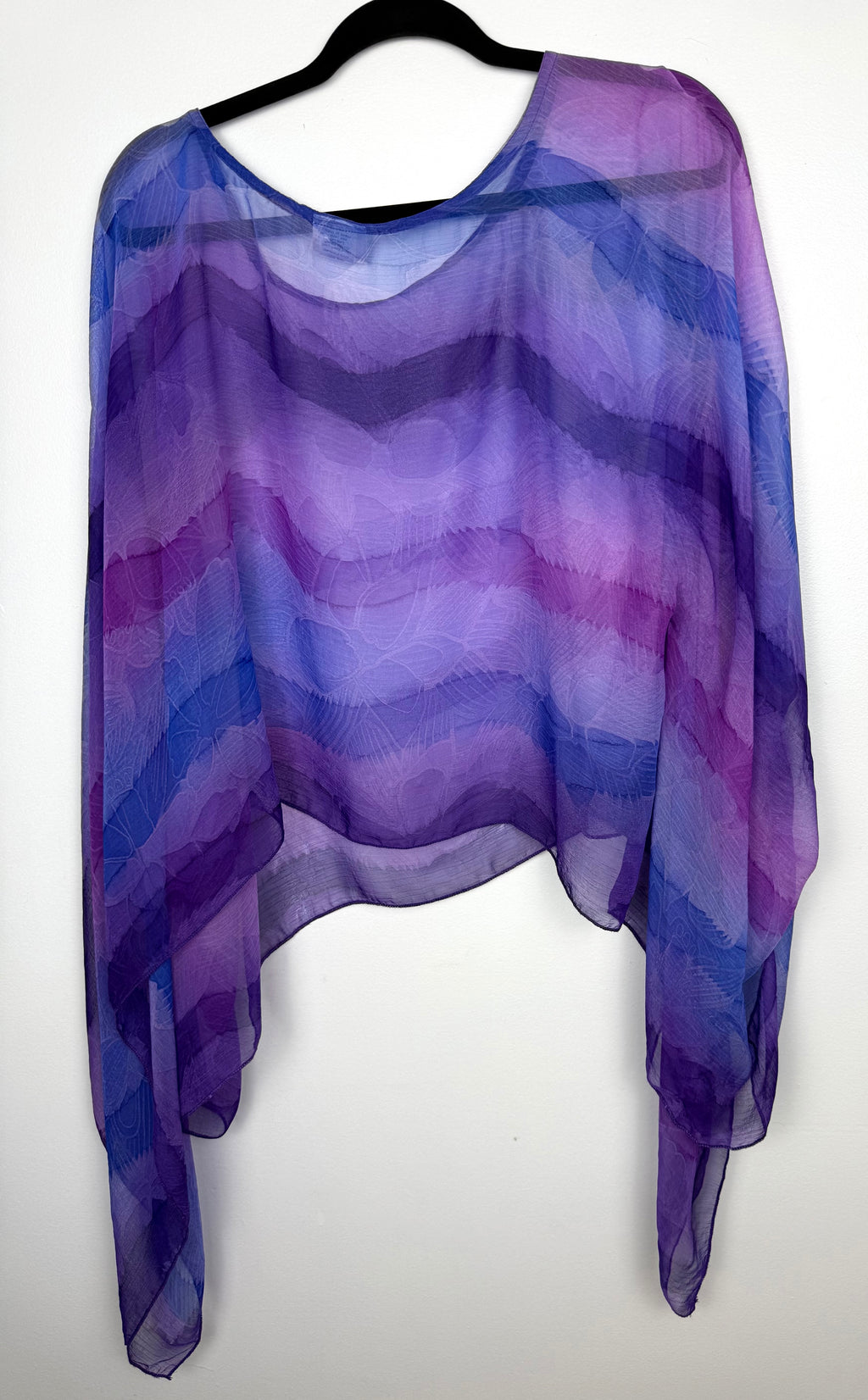 back of Sheer Batwing Poncho Top | One Size at Blue Sparrow Resale Shop on hanger