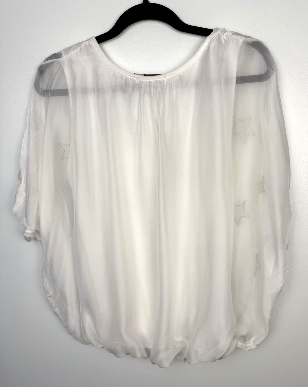back of Tendenze made in italy star print overlay top on hanger