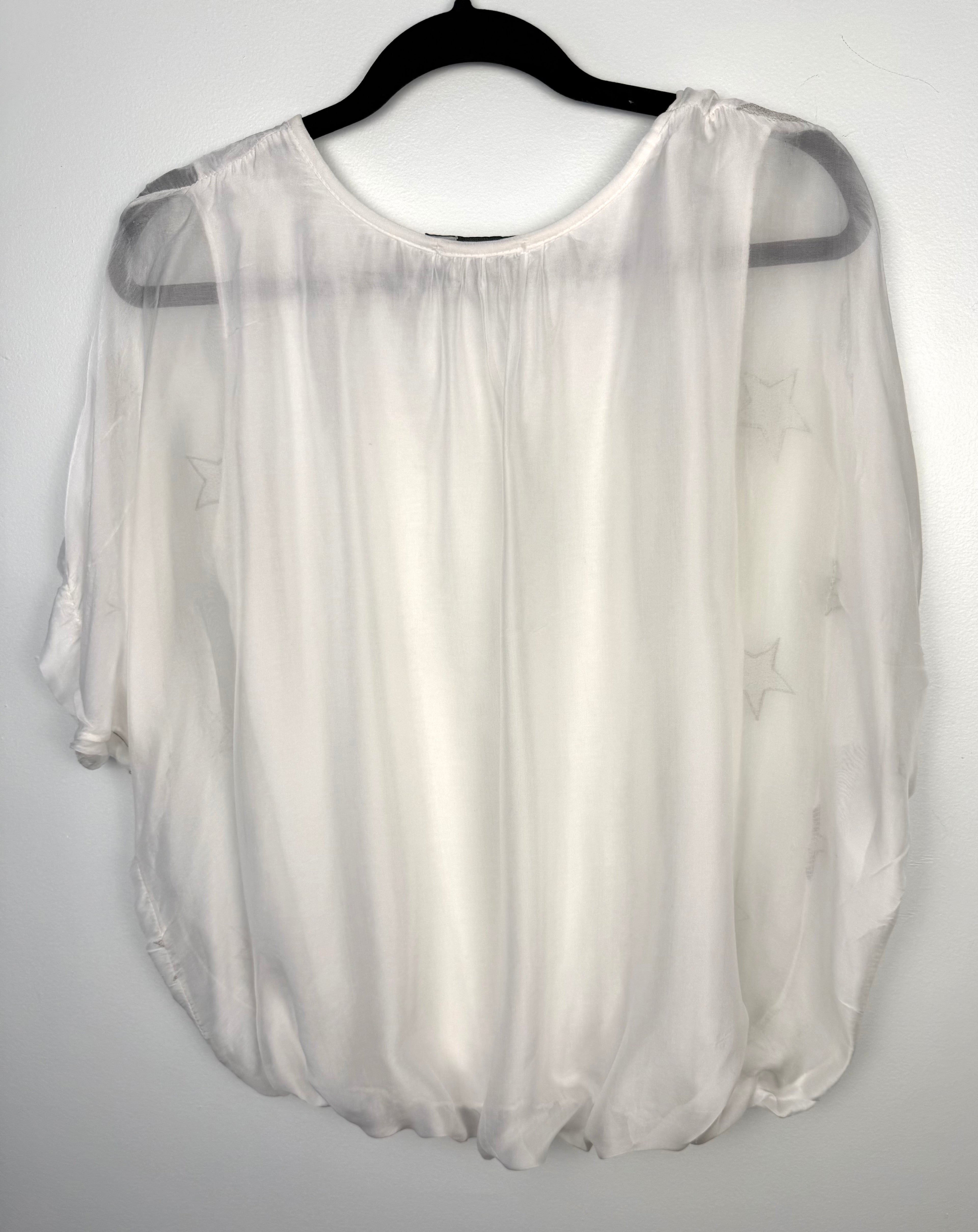 back of Tendenze made in italy star print overlay top on hanger