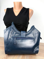 back of Vintage Leather Purse by LAND beside mannequin to show scale 