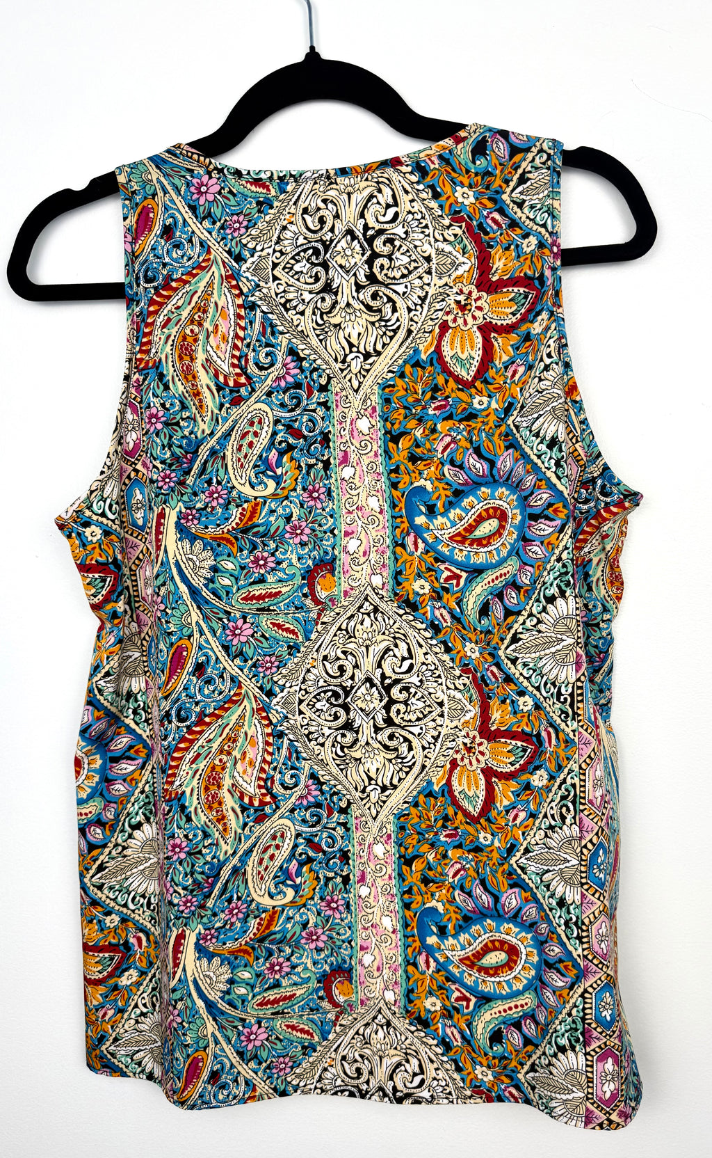 back of colourful paisley bohemian blouse with crochet lace neckline on hanger