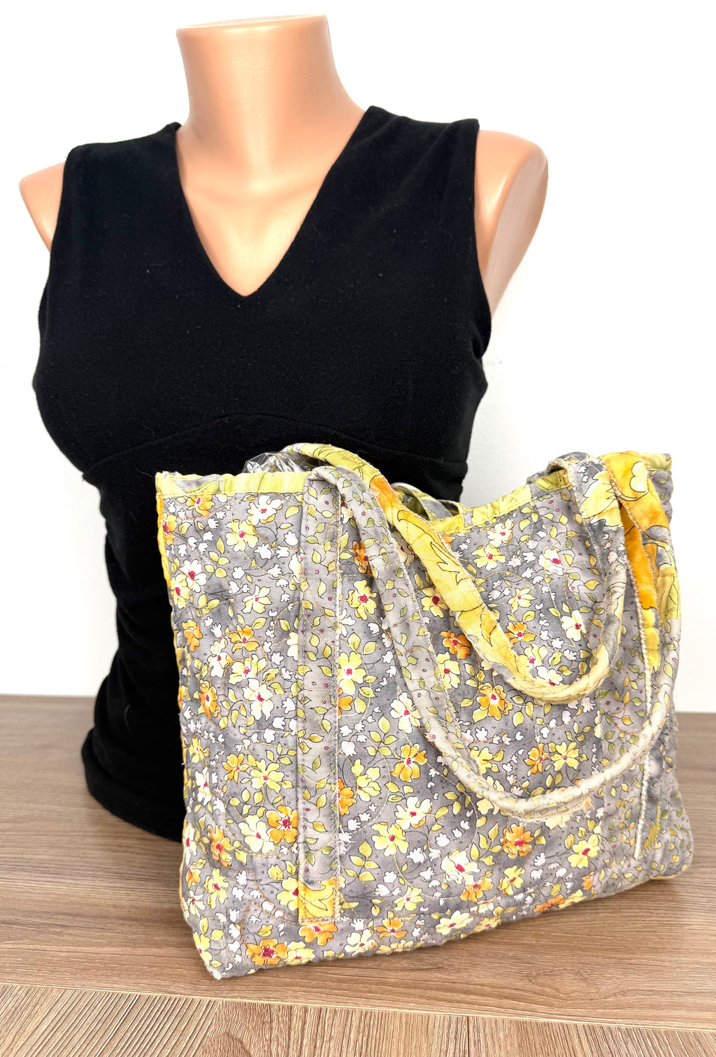 back of handmade artisan quilted cotton bag in front of mannequin to show scale 