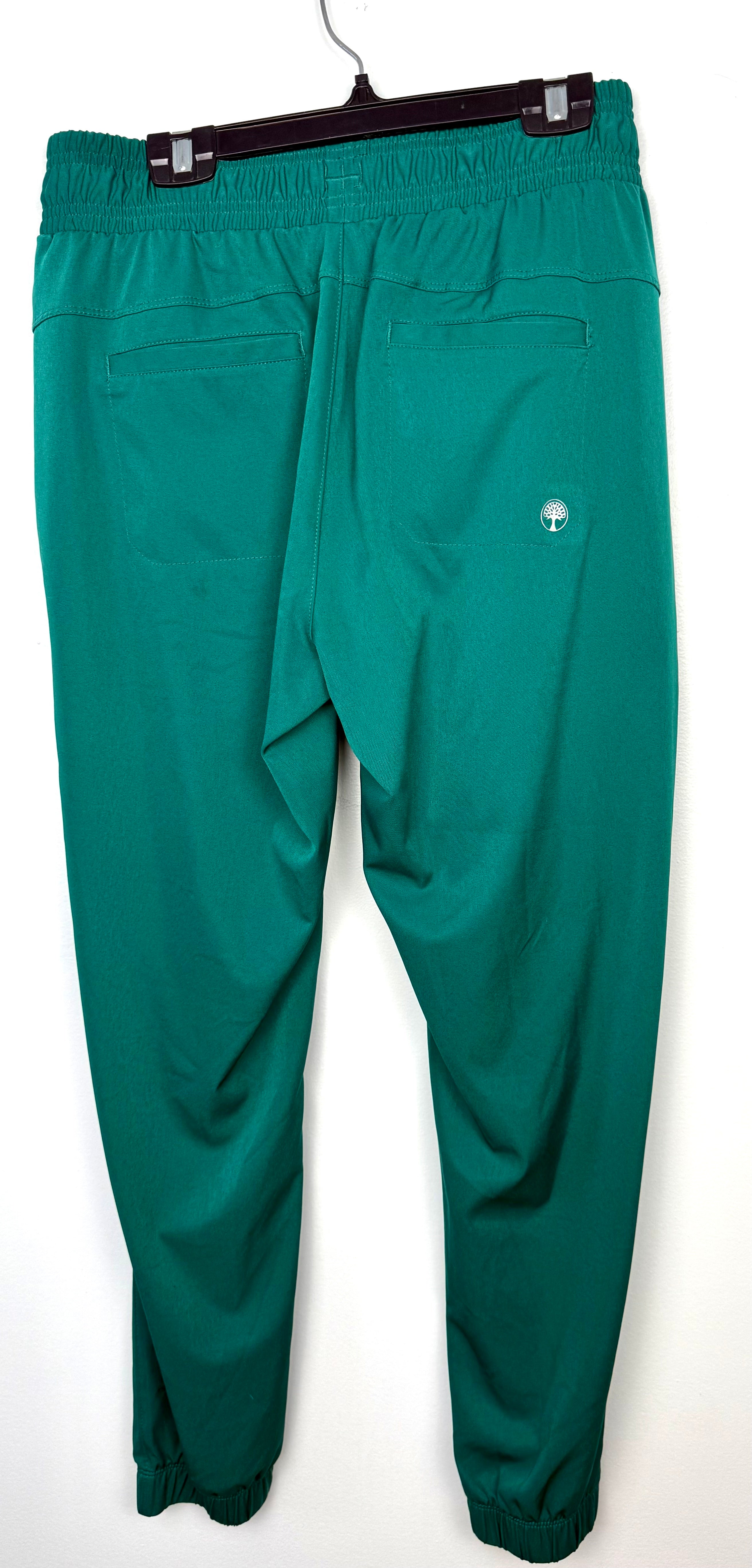 back view of  Healing Hands scrub pants / casual pants in emerald green showing healing hands logo 