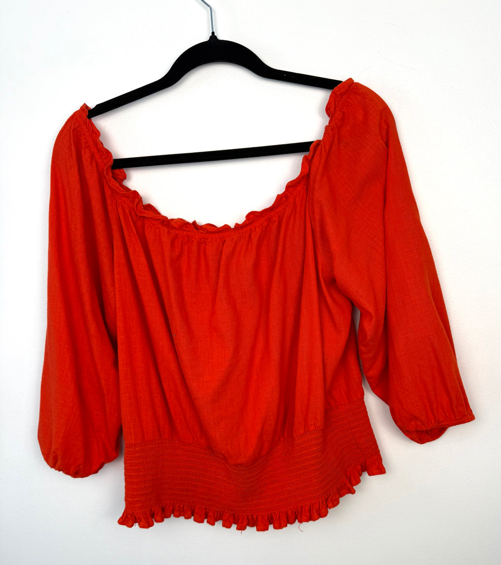 back view of Melanie Lyne orange peasant blouse on hanger