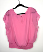 back view of Melanie Lyne pink chiffon blouse with smocked waist and flutter sleeves on hanger