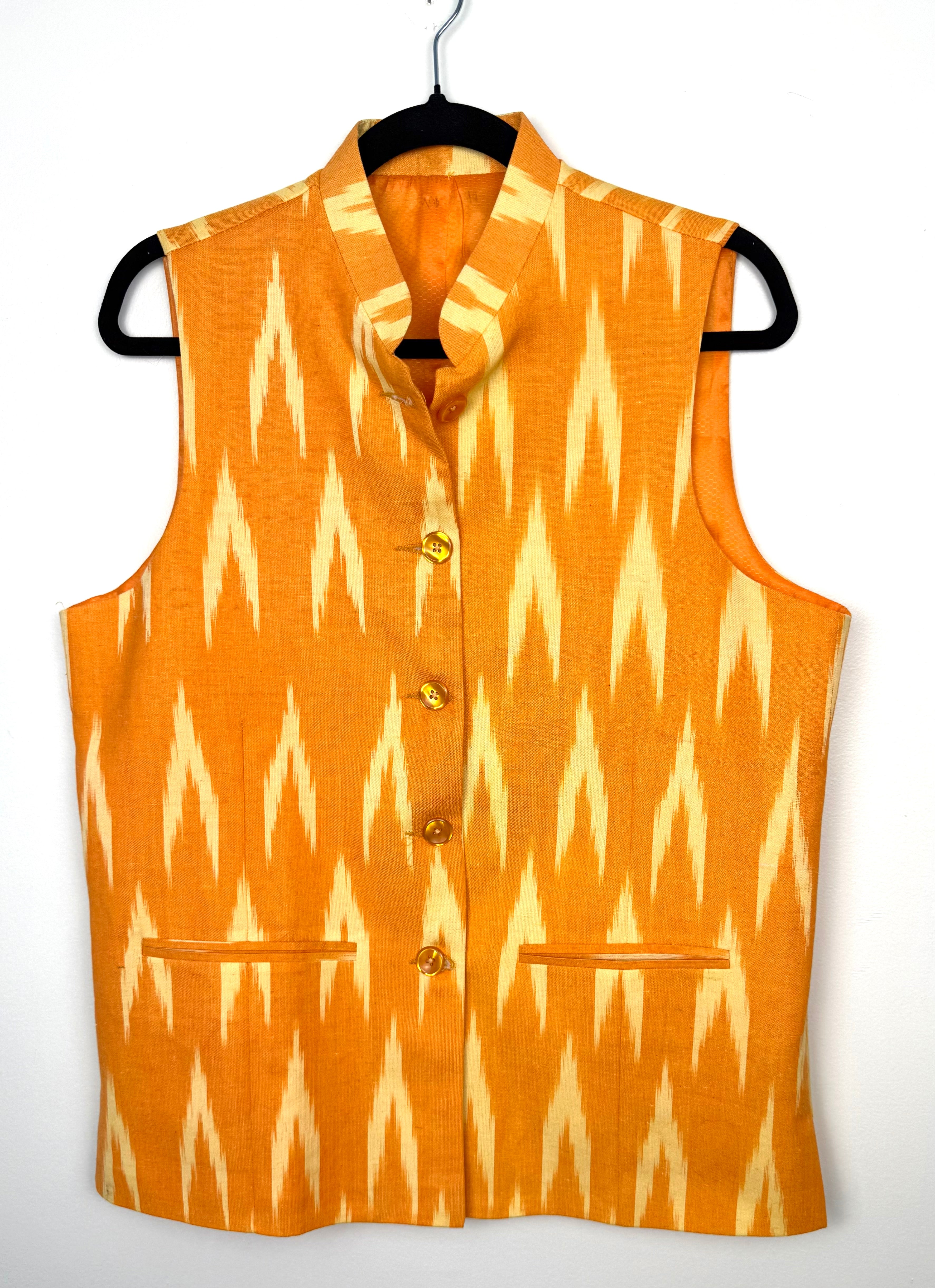 boho chic structured vest in ikat print vintage looking vest  statement wardrobe piece  showing buttoned on hanger 
