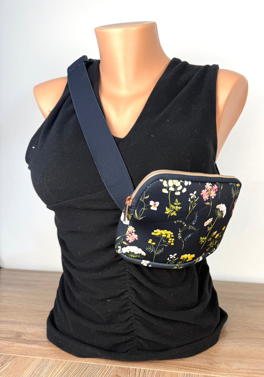 botanical print waist bag with adjustable strap on mannequin to show size 