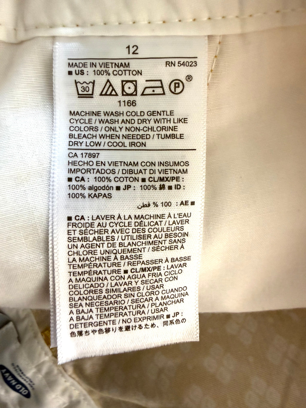 care tags inside NWT Old Navy 100% Cotton Mustard Floral Print Chino Shorts — 5" | Size 12 at Blue Sparrow Shop